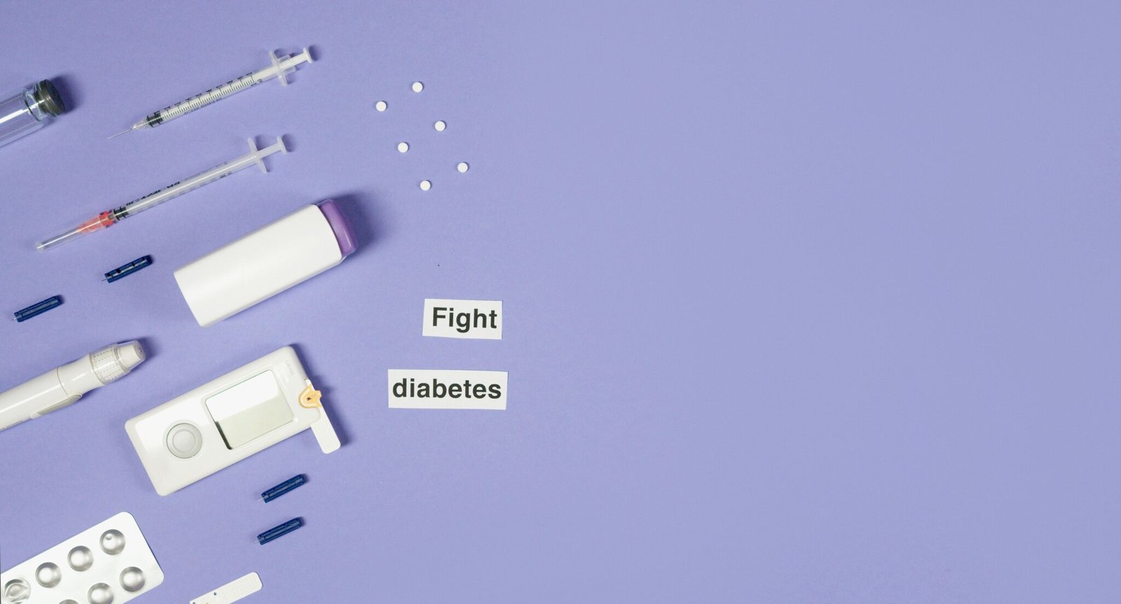 A flat lay of diabetes management tools, including syringes and pills, on a purple background.